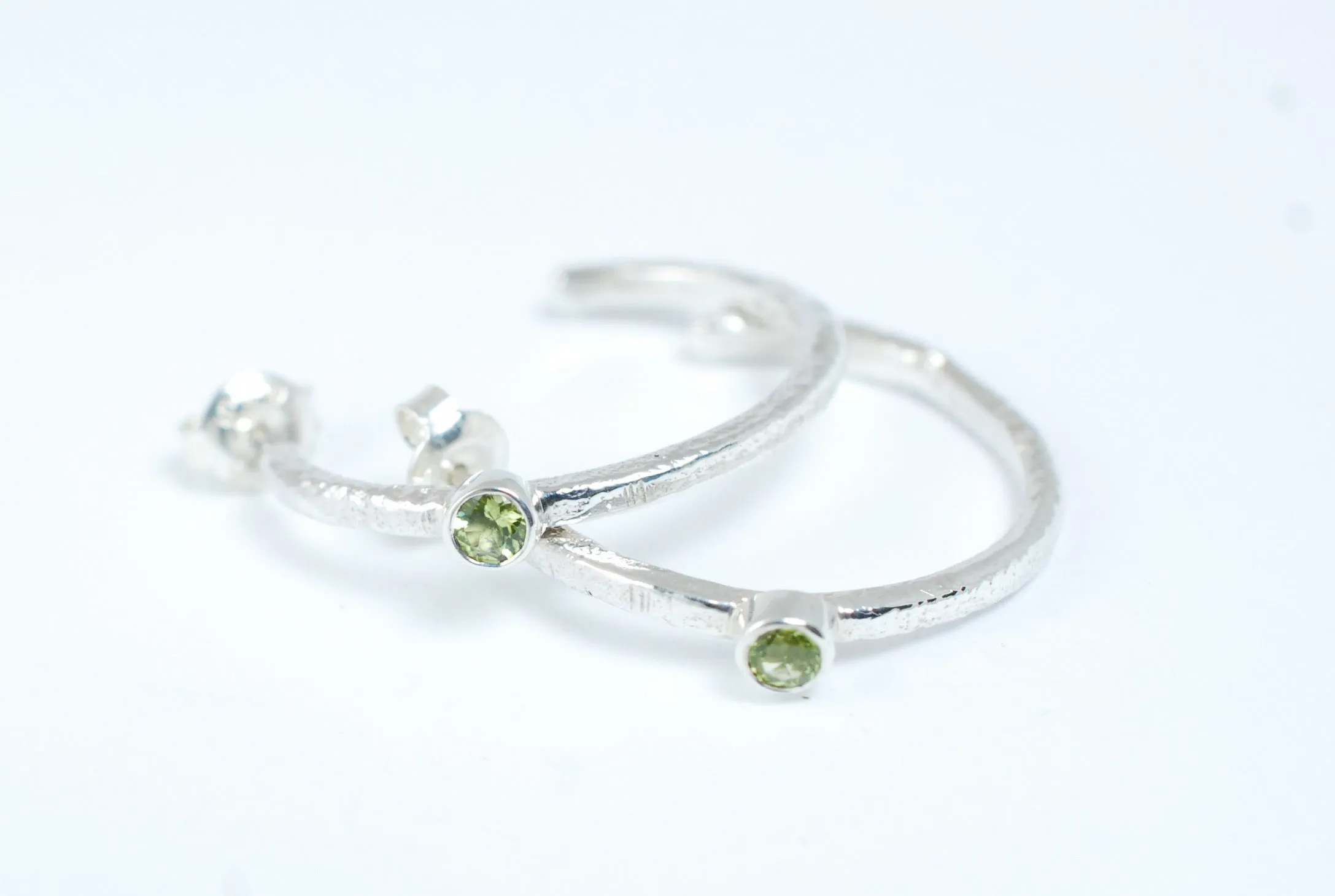 Silver hoops earrings with green peridot stone
