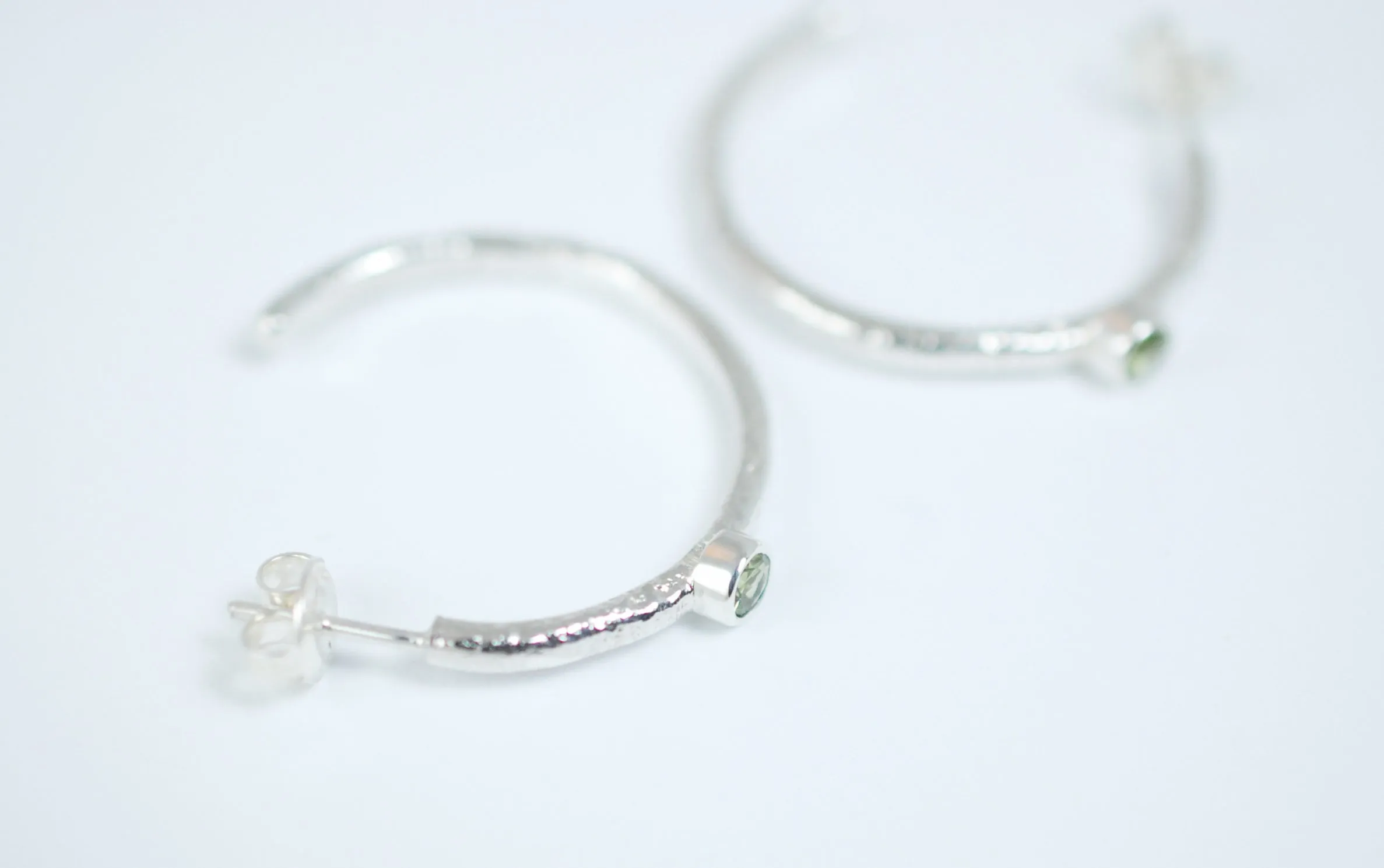 Silver hoops earrings with green peridot stone