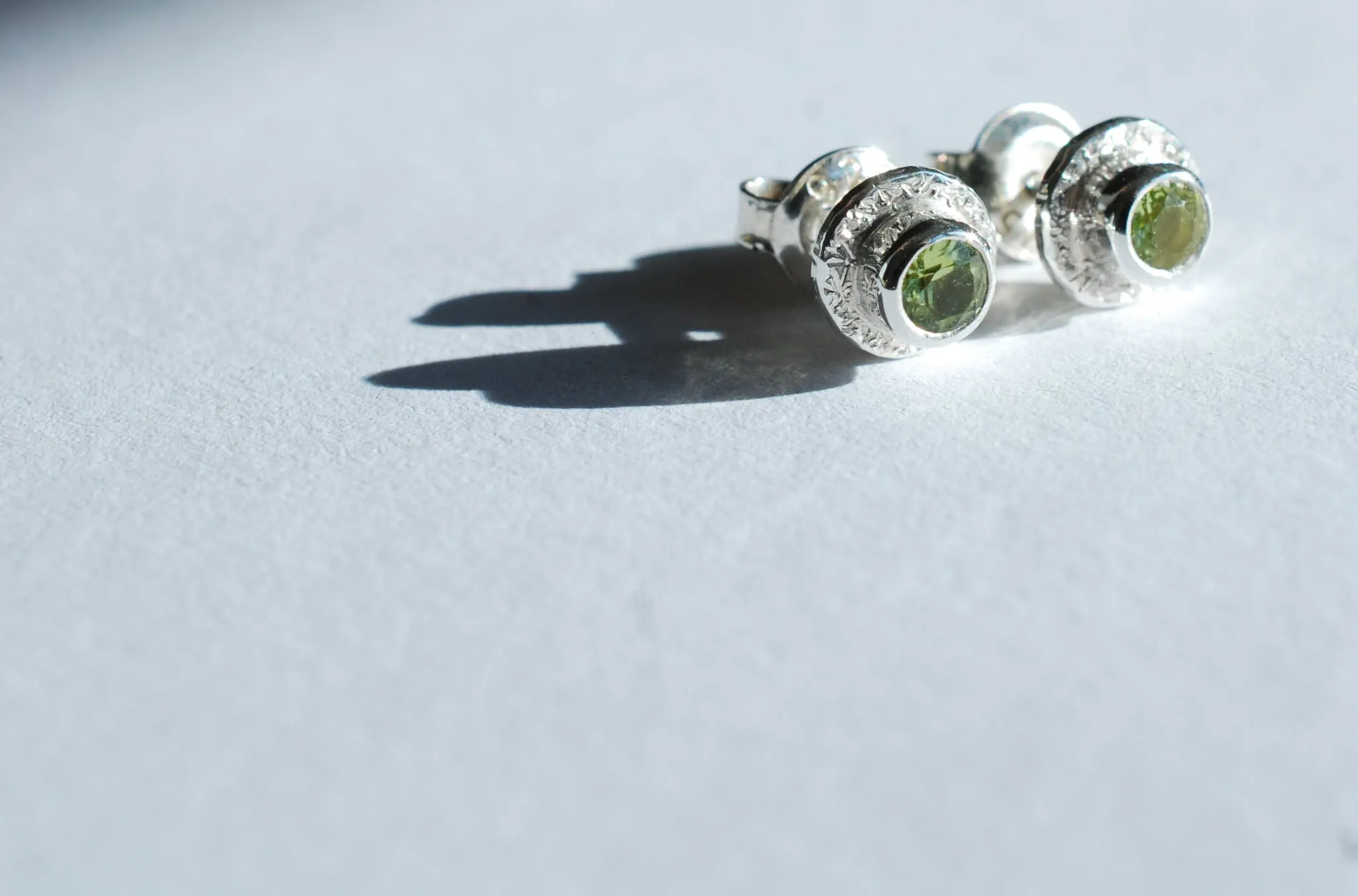 Silver stud earrings with green Peridot gemstone