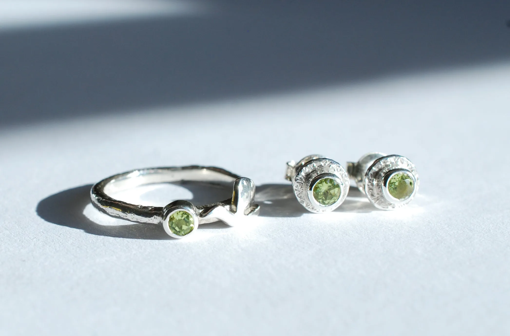 Silver stud earrings with green Peridot gemstone